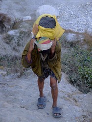 Nepalese man carrying grave from a mine